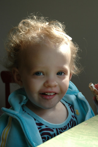 Donna eating a snack in her blue jacket
