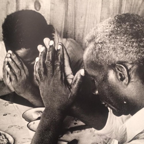 The Fair family from Greenfield, Mississippi, pray over the meager, depression era lunch.