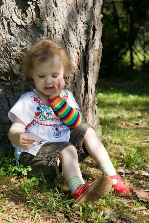 Donna being so very Donna. Sitting under a tree, thinking. She is wearing a combination of cargo shorts and a delicate floral top. And red mary jane shoes. Always red mary janes.